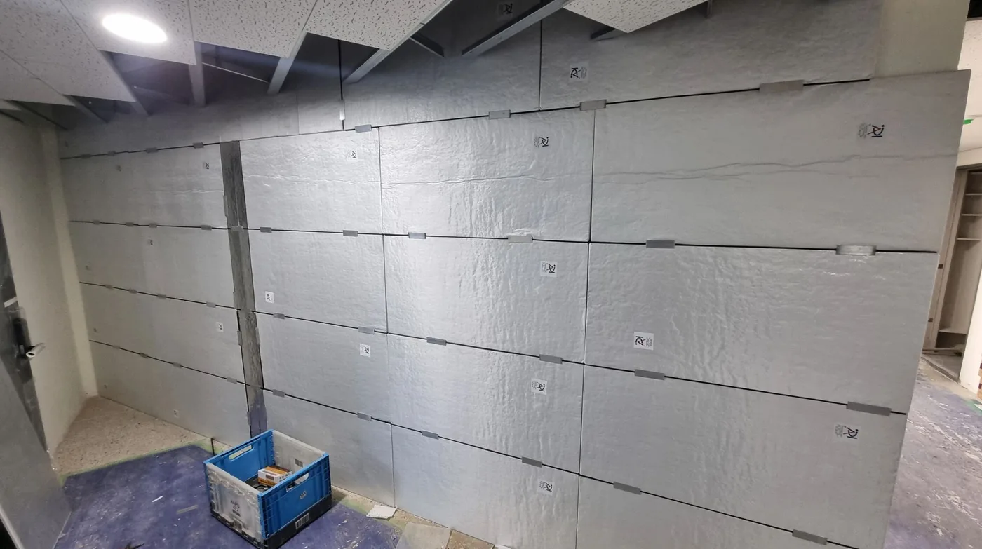 Vacuum insulation panels installed across an interior wall